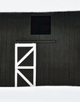 a close up of a charcoal colored barn in a wintery Vermont scene