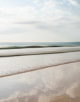 Abstract beach scene with waves receding into the distance with blue and beige undertones