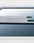 Framed photograph of a dock extending into calm water