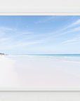 Framed photograph of a beach with clear blue sky and white sand.