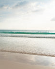 Beach scene with green waves gently lapping against the shore on Harbour Island, Bahamas