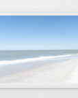 Framed artwork of an abstract beach scene with soothing blue sky, ocean and sand.