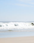 Beach scene with white waves and surf in the ocean, clear skies and beige sand taken at Nauset Beach