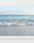 This image presents a serene and beautiful artwork titled "Ocean Club" from the collection in Nassau, Bahamas. It features a framed print with a soft, minimalist design, showcasing a tranquil ocean scene with gentle waves meeting the shore.
