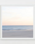 An abstract photograph of a soft and serene beach scene with a calm ocean, clear sky and blue, beige and pink tones