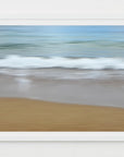This image displays a framed artwork titled "sandy shore." The artwork captures a serene beach scene with gentle waves lapping against the shore.
