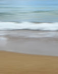 This beach scape abstract captures a serene beach scene with gentle waves lapping against the shore.