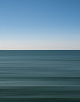 Calm ocean abstract with deep blue hues and clear blue sky