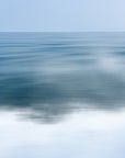 This image displays "Water Abstract 8," a captivating art piece that captures the serene expanse of the Cape Cod ocean. The artwork strips away the clutter of detail, offering a minimalist and ethereal portrayal of the water in shades of blue and white.