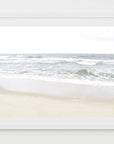 This artwork titled "Calm Beach," featuring a serene beach scene from Cisco Beach, Nantucket. The artwork captures the tranquil interaction of ocean waves with the shore, framed in a simple white frame that enhances its minimalist aesthetic.