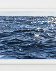 This image features a captivating photograph titled "Deep Waters," showcasing the serene and expansive Nantucket Sound. The composition captures the calming effect of the ocean waves, highlighted by the gentle sparkle of sunlight reflecting off the water's surface.