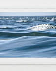 This image displays an artwork titled "In Motion," featuring a captivating photograph of deep and gentle blue ocean waves.