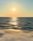 A scenic view of the ocean with a golden sunset glow, reflecting on the water surface.
