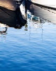 Boats reflecting on vibrant blue waters