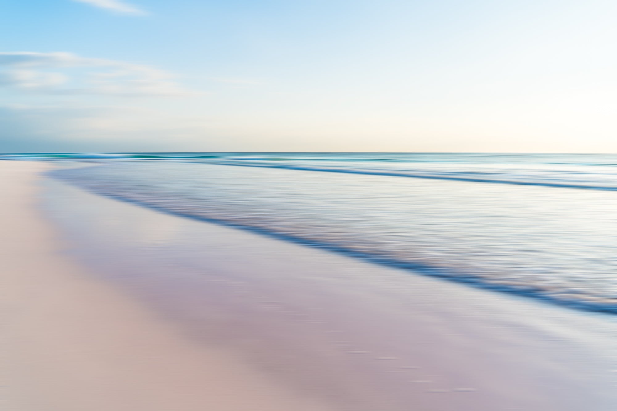Abstract beach scene with blurred pink sand and turquoise water on Harbour Island