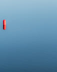 Red buoy on vibrant blue water