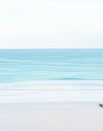 Minimalist scene with a white truck on pink sands beach with turquoise still waters