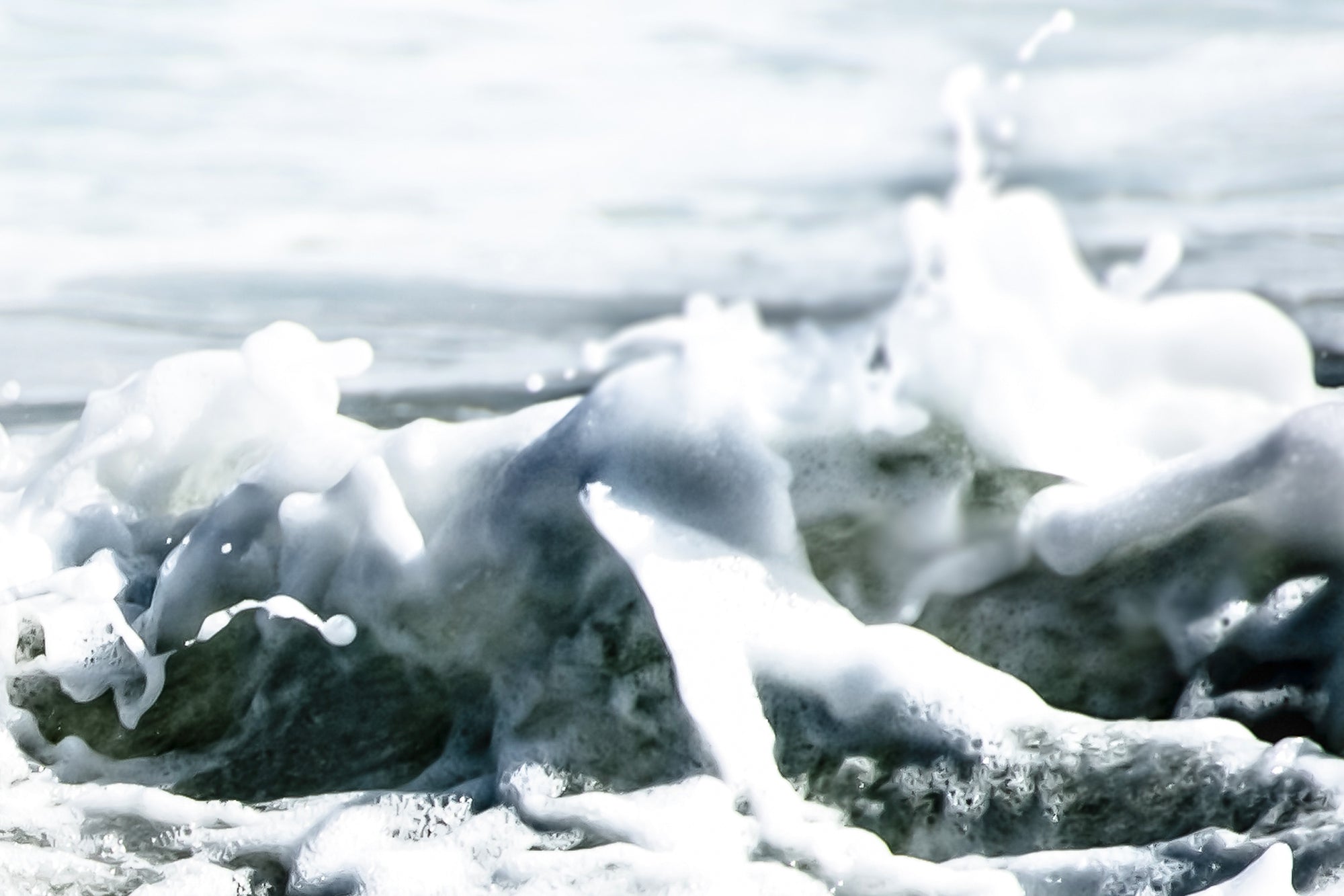 Close-up of frothy water sea foam with a blurred background