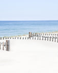 This image titled "beach days," featuring a serene and idyllic beach scene from Nauset Beach, Cape Cod. The artwork displays a wide sandy beach leading up to a wooden fence that borders the ocean.