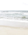This artwork titled "Calm Beach," featuring a serene beach scene from Cisco Beach, Nantucket. The artwork captures the tranquil interaction of ocean waves with the shore, framed in a simple white frame that enhances its minimalist aesthetic.
